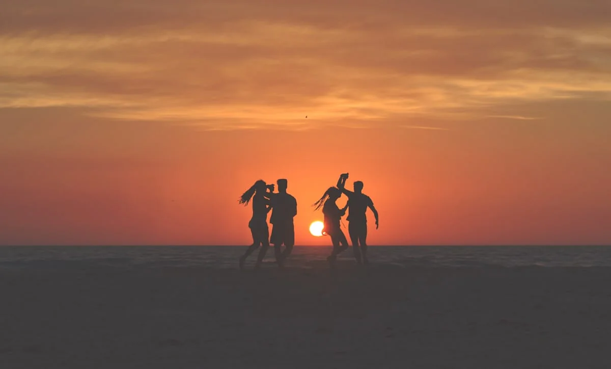 Group of dancers moving at sunset