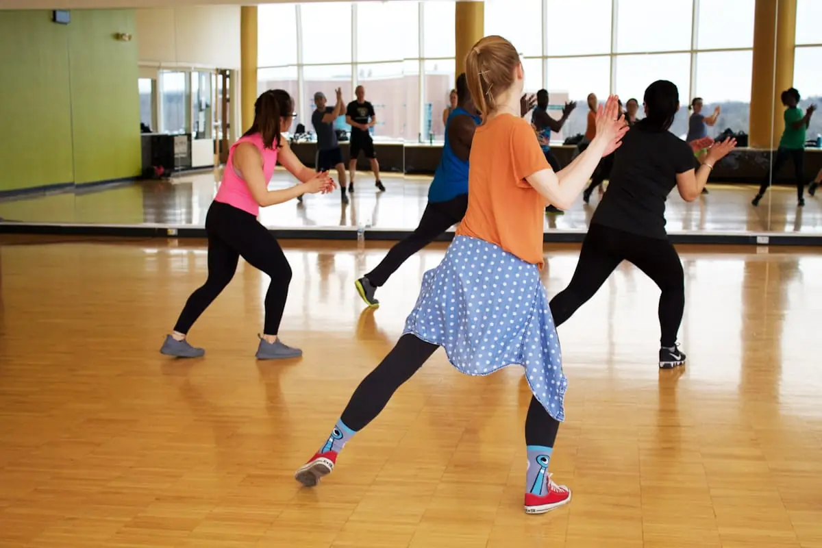Dance class rehearsing together in a bright studio