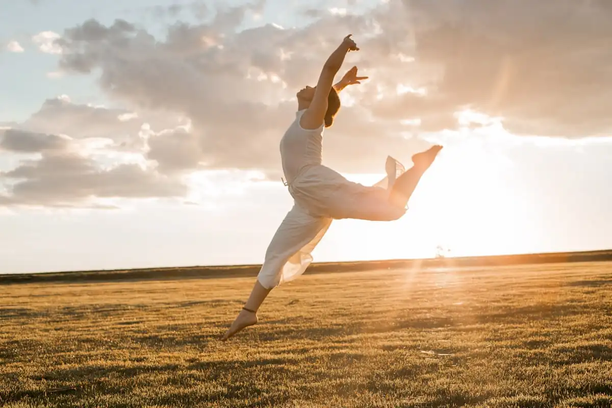 Dancer leaping outdoors at sunset
